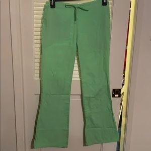Lime green Cherokee flare scrub pants.